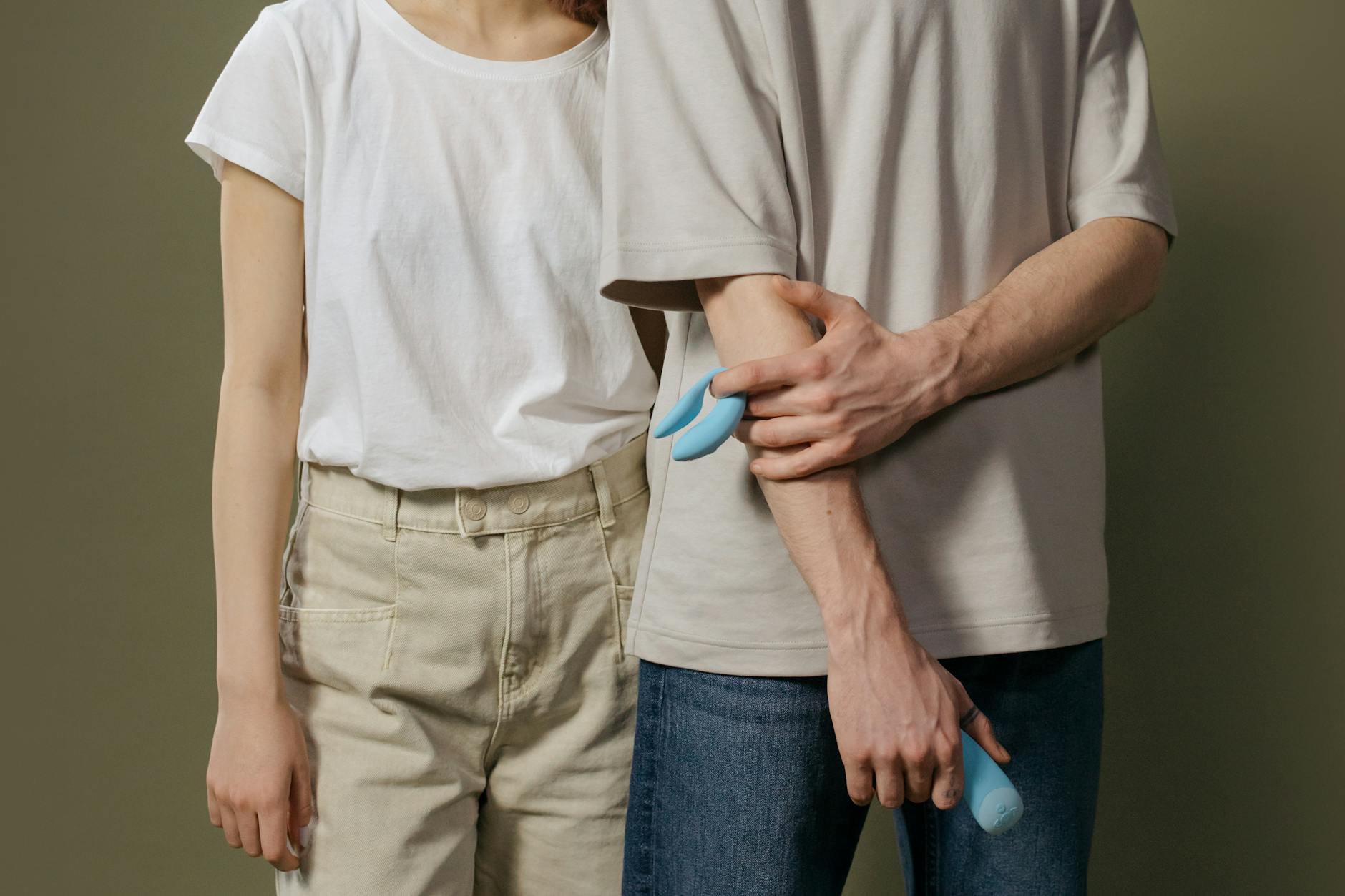A couple holding a blue vibrator together, representing modern midlife intimacy and exploration